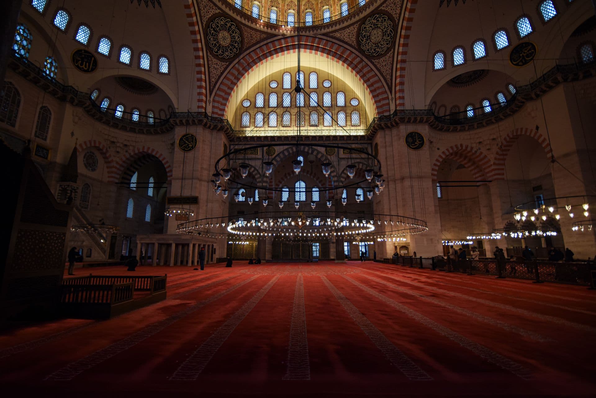The warm, lantern-lit interior of a mosque